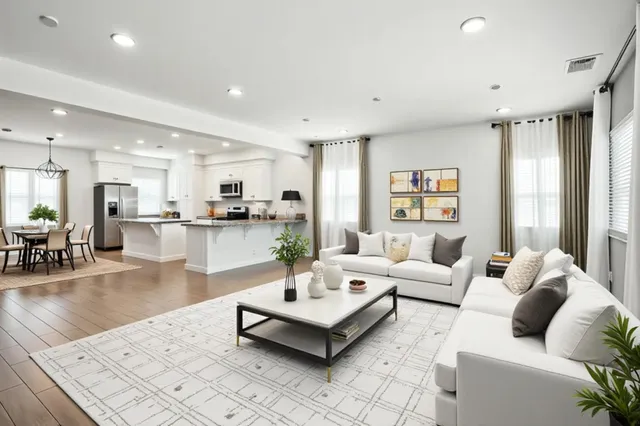 a living room with furniture and view of kitchen