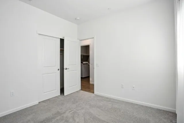 a bathroom with a sink double vanity granite tub shower and a mirror