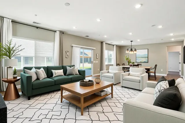 a living room with furniture a table and a large window
