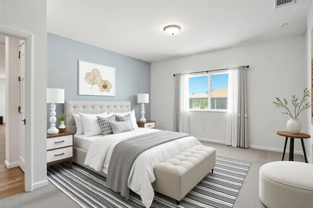 a bedroom with a bed and a painting on the wall