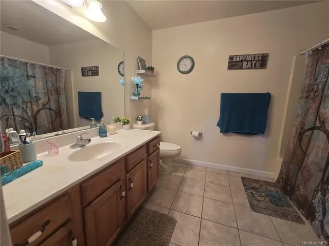 a bathroom with a double vanity sink a mirror and a shower