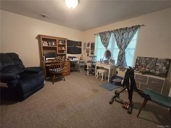 a living room with furniture a flat screen tv and a large window