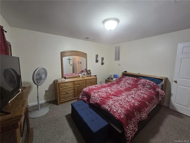 a bed room with a bed closet and mirror
