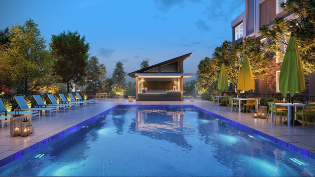a view of a swimming pool with sitting area