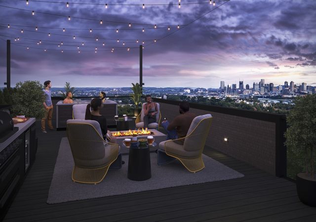 a roof deck with table and chairs