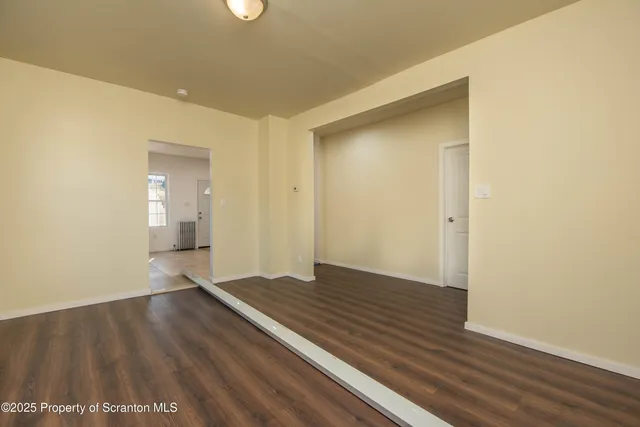 a view of a big room with wooden floor and closet