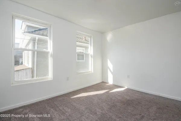 a bathroom with a toilet and a large window