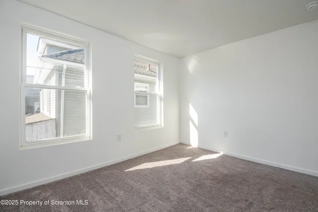 a bathroom with a toilet and a large window