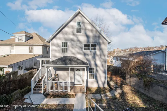 a view of a house with wooden deck