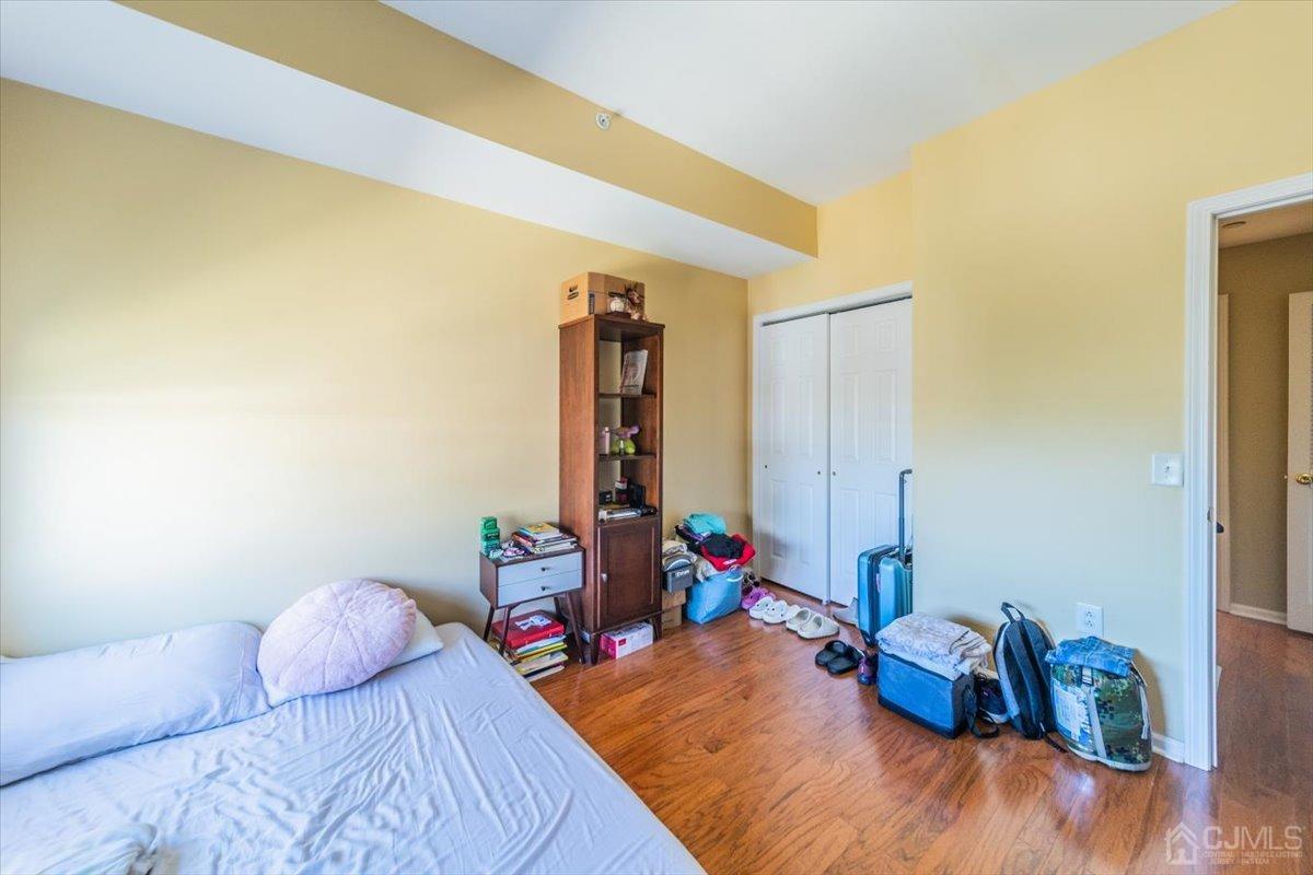358 Rector Street, Unit 509 Perth Amboy, NJ 08861 - Photo 13 of 26 a bedroom with bed and wooden floor