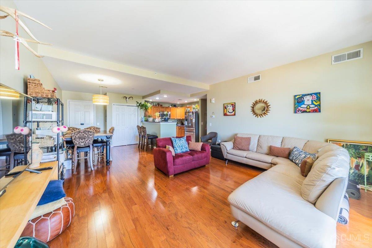 358 Rector Street, Unit 509 Perth Amboy, NJ 08861 - Photo 5 of 26 a living room with furniture and wooden floor
