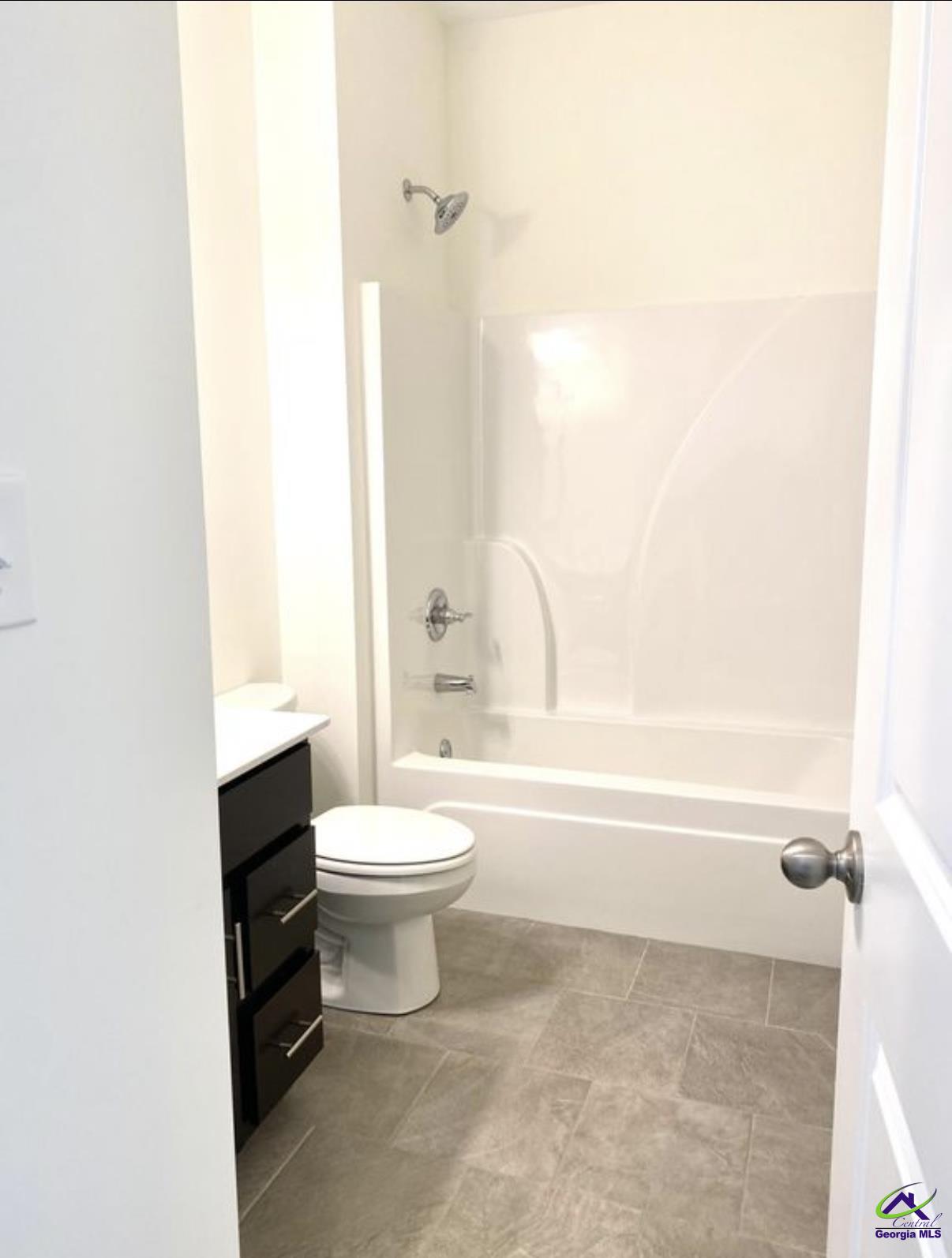 123 West River Cane Run Perry, GA 31069 - Photo 11 of 21 a bathroom with a toilet a sink and a bathtub