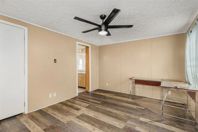 a bedroom with a bed and a ceiling fan