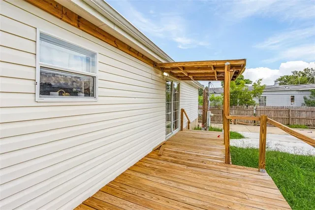 a view of a balcony with wooden floor and stairs