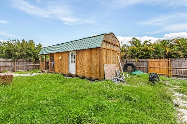a view of a house with a backyard and a garden