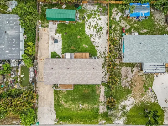 an aerial view of residential houses with outdoor space and river