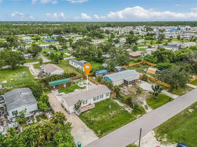 an aerial view of residential houses with outdoor space and street view
