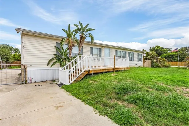 a view of a house with a backyard and a small yard