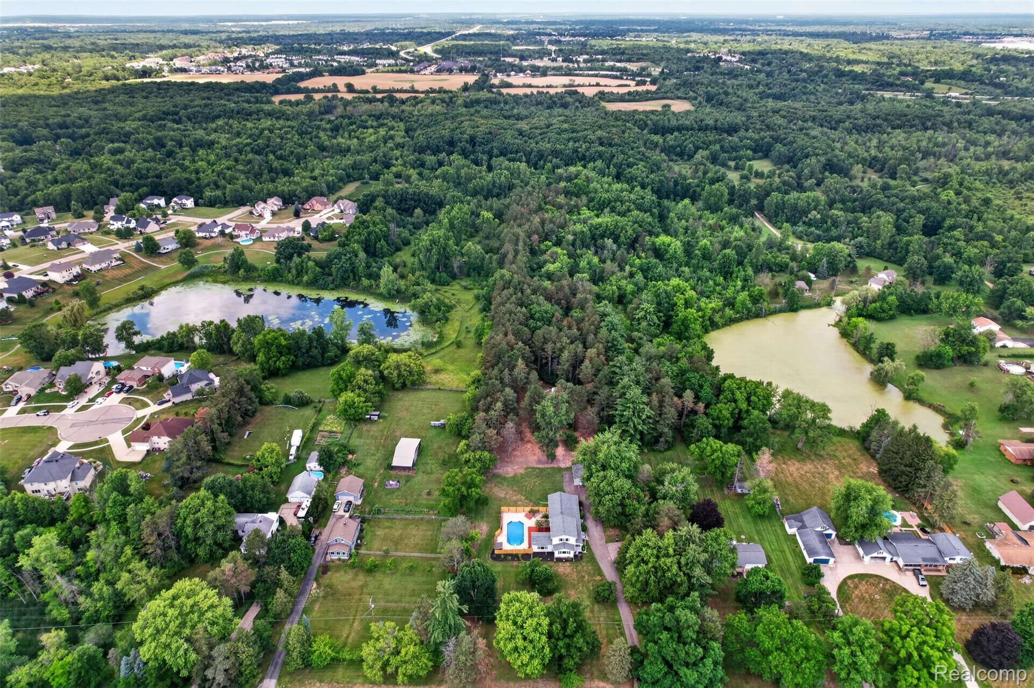 1437 East Cook Road Grand Blanc, MI 48439 - Photo 24 of 69 Expansive property featuring a private swimming pool, surrounded by mature trees and green landscaping