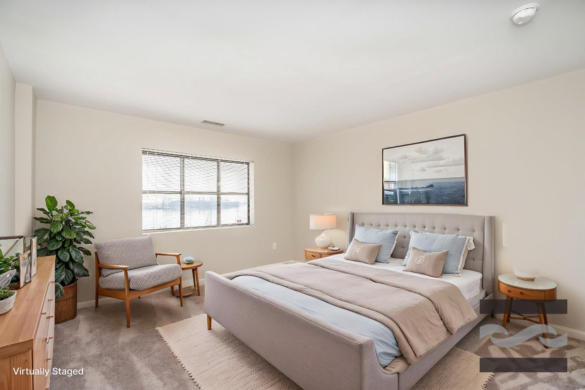 2702 Lighthouse Point East, Unit 532 Baltimore, MD 21224 - Photo 2 of 44 a bedroom with a bed and a couch