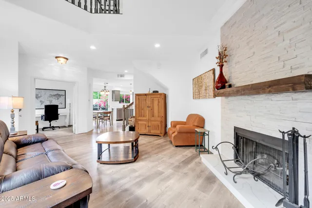 a living room with furniture and a fireplace