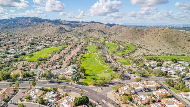 a view of a swimming pool with a table and chairs