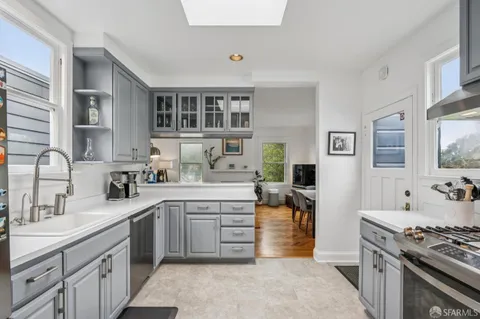 a kitchen with stainless steel appliances granite countertop a stove and a sink