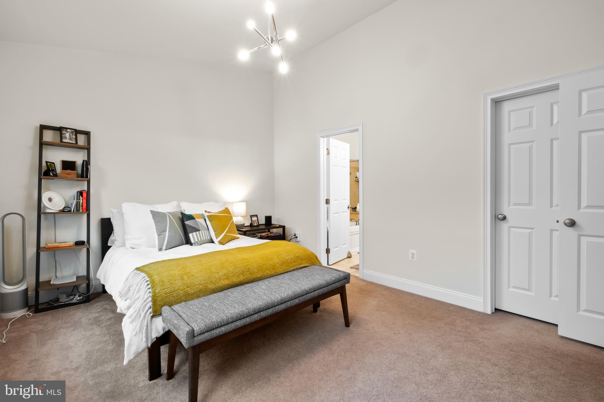 112 Commodore Court Philadelphia, PA 19146 - Photo 22 of 55 a bedroom with a bed and a chandelier