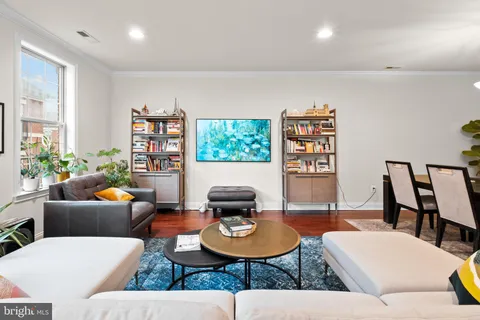 a living room with furniture and a book shelf