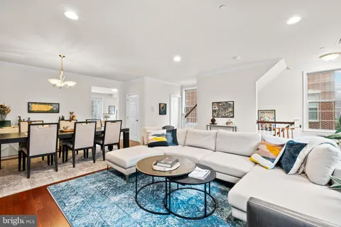 a living room with furniture a rug and a table