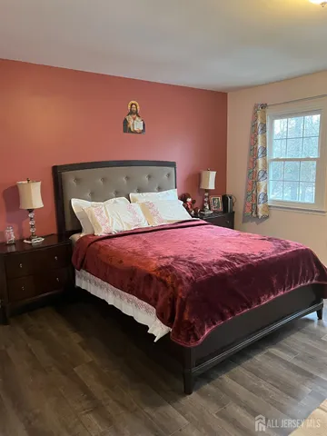 a bedroom with a bed and window
