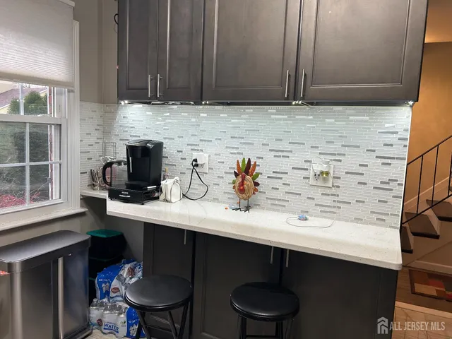 a kitchen with a sink cabinets and a window