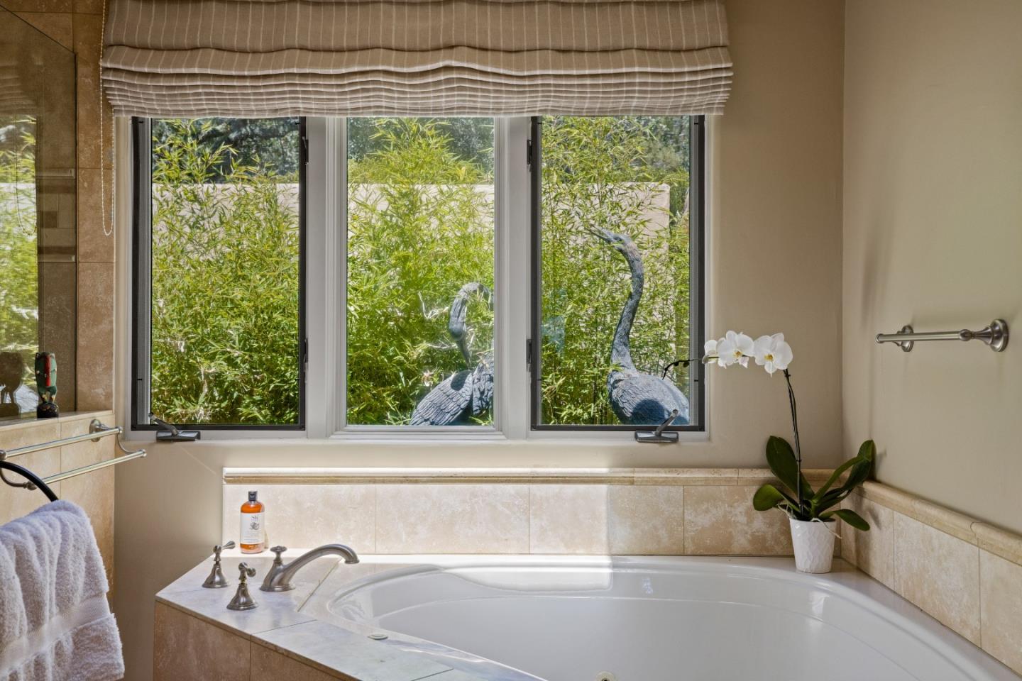 11502 Saddle Road Monterey, CA 93940 - Photo 16 of 40 a bath tub sitting in a bathroom next to a window