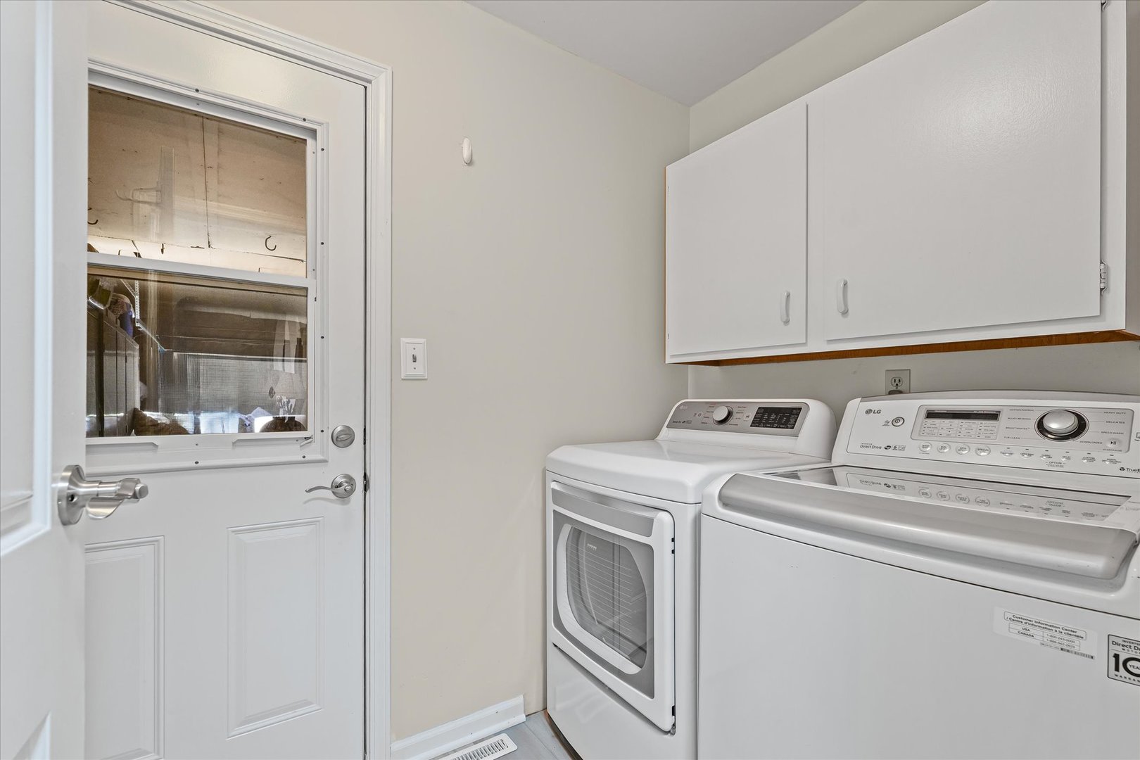 1106 South Spring Lake Road Mahomet, IL 61853 - Photo 18 of 36 a view of washer and dryer with kitchen in the background