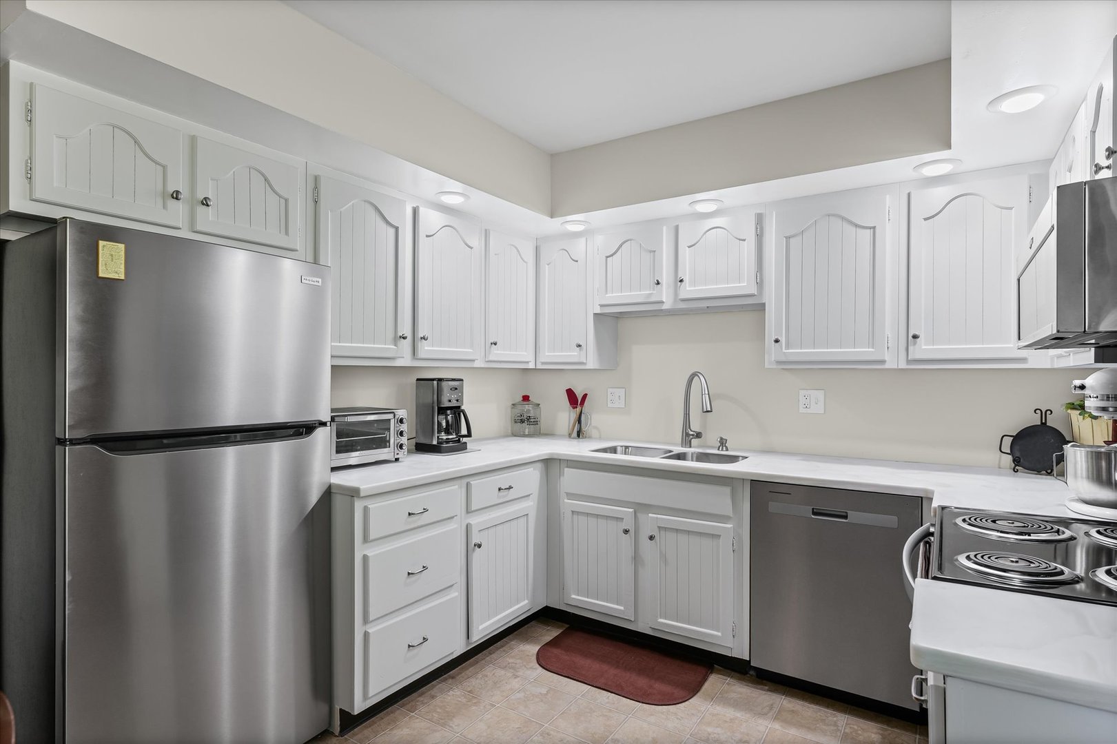 1106 South Spring Lake Road Mahomet, IL 61853 - Photo 23 of 36 a kitchen with white cabinets and white stainless steel appliances