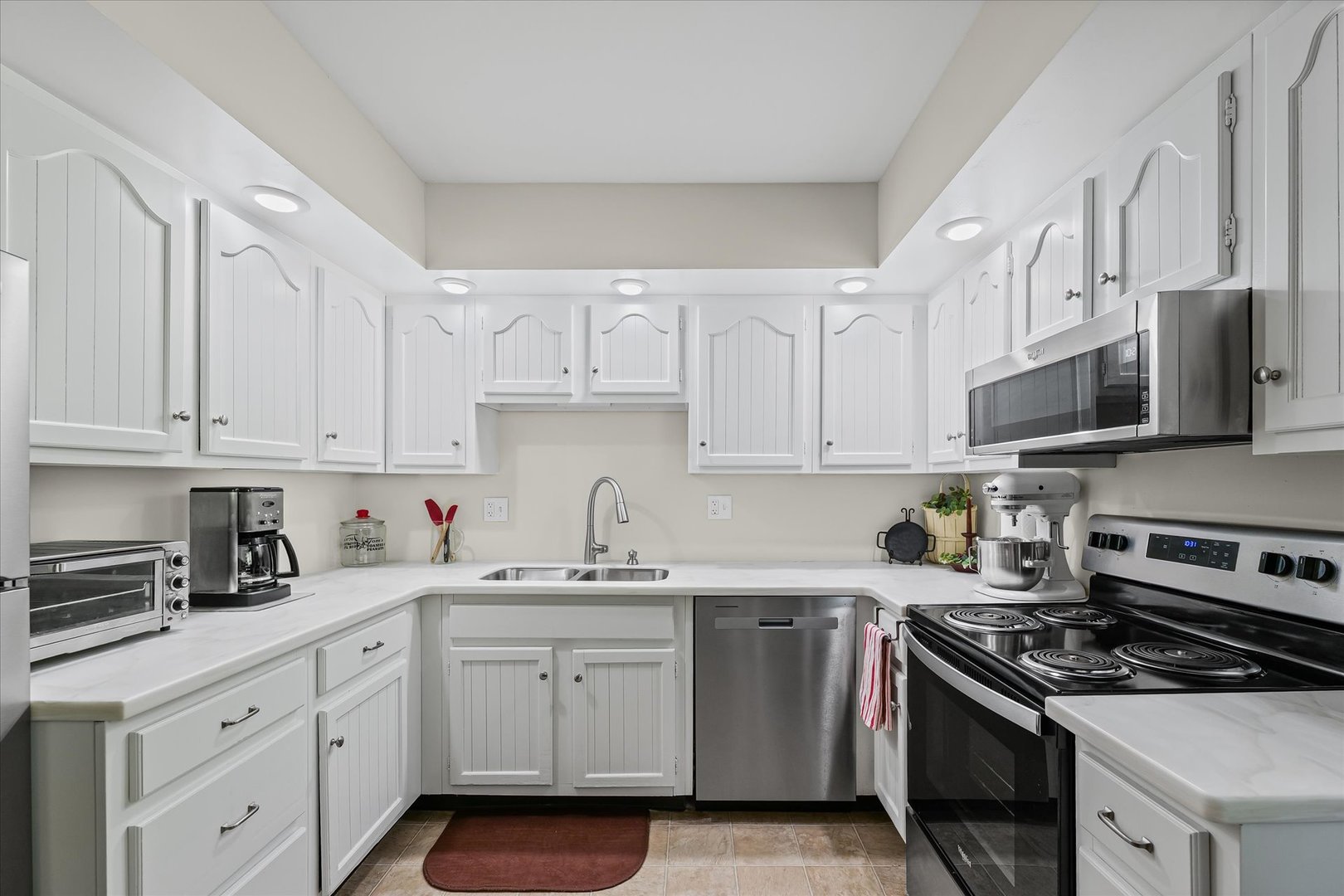 1106 South Spring Lake Road Mahomet, IL 61853 - Photo 24 of 36 a kitchen with stainless steel appliances granite countertop white cabinets a sink a stove a refrigerator and white cabinets