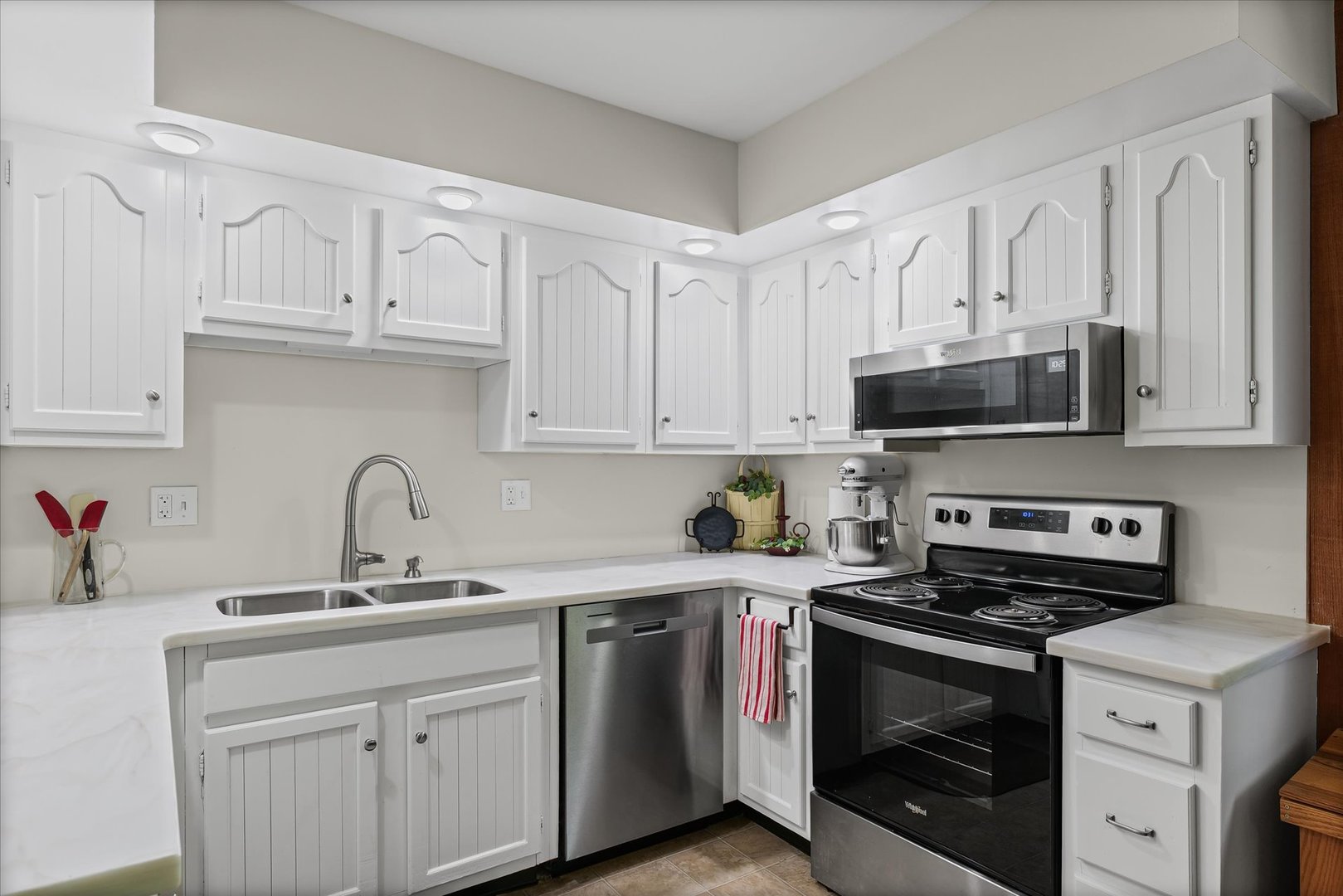 1106 South Spring Lake Road Mahomet, IL 61853 - Photo 25 of 36 a kitchen with stainless steel appliances granite countertop a sink dishwasher a stove and a microwave oven with cabinets