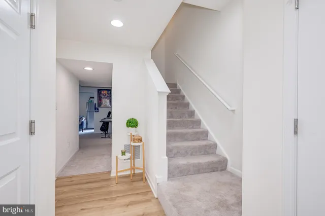 a view of entryway and hall with wooden floor