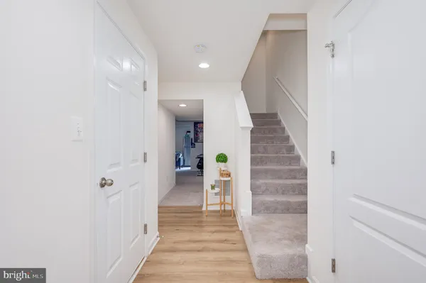 a view of a hallway with wooden floor and entryway