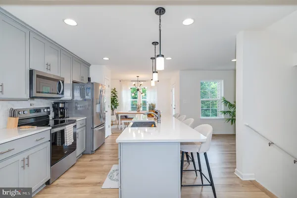 a kitchen with a sink a counter top space stainless steel appliances and a window