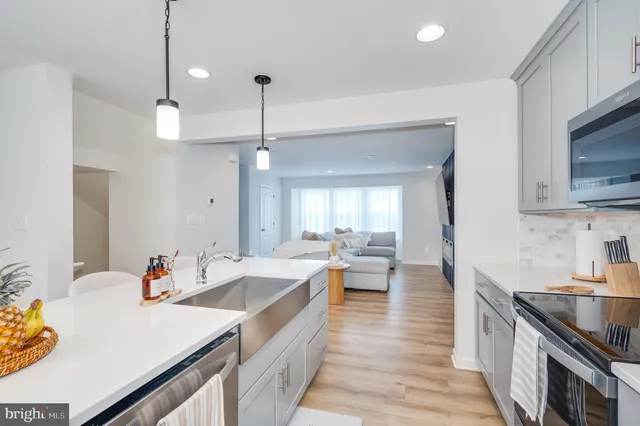 a view of a room with wooden floor and potted plants