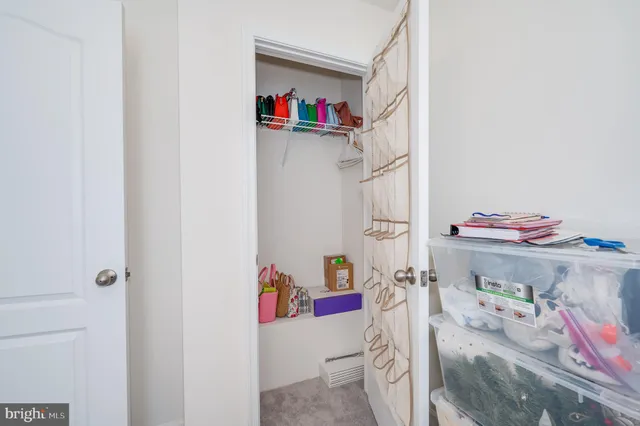a bedroom with a bed and a potted plant