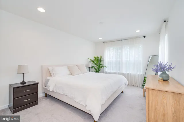 a bathroom with a tub a sink and mirror