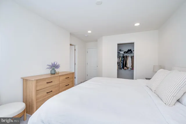 a bathroom with a sink a mirror and a potted plant