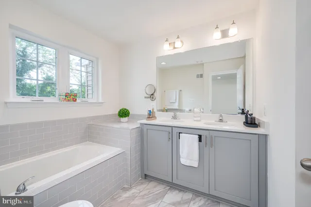 a bathroom with a granite countertop sink a shower and a mirror