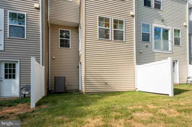 a view of a backyard with a white house