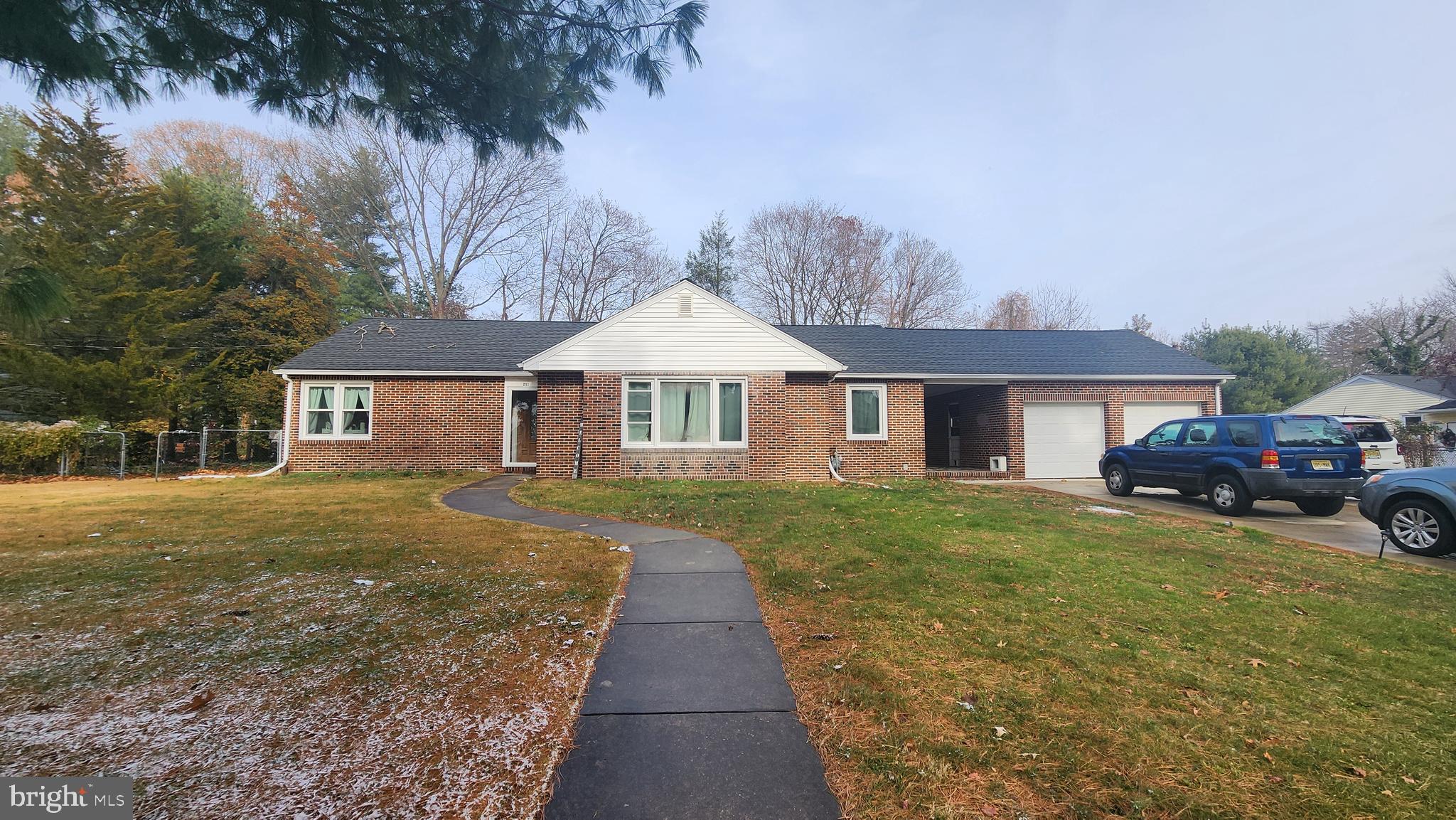 211 University Boulevard Glassboro, NJ 08028 - Photo 2 of 22 a front view of a house with a garden and trees