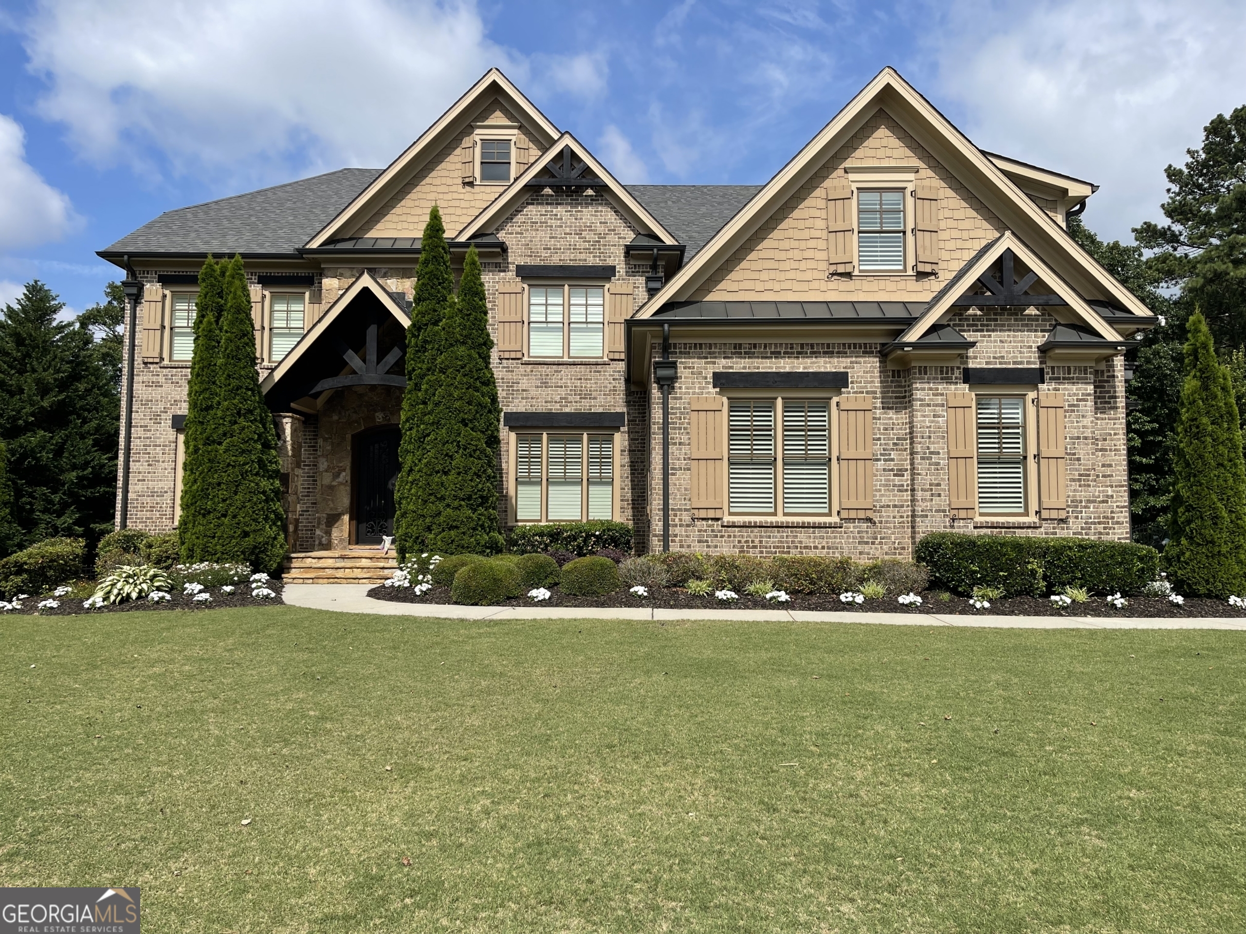 a front view of a house with a yard
