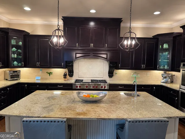 a kitchen with a sink a stove and chairs