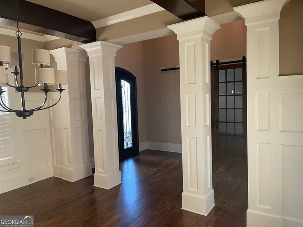 a kitchen with a sink a stove and chairs
